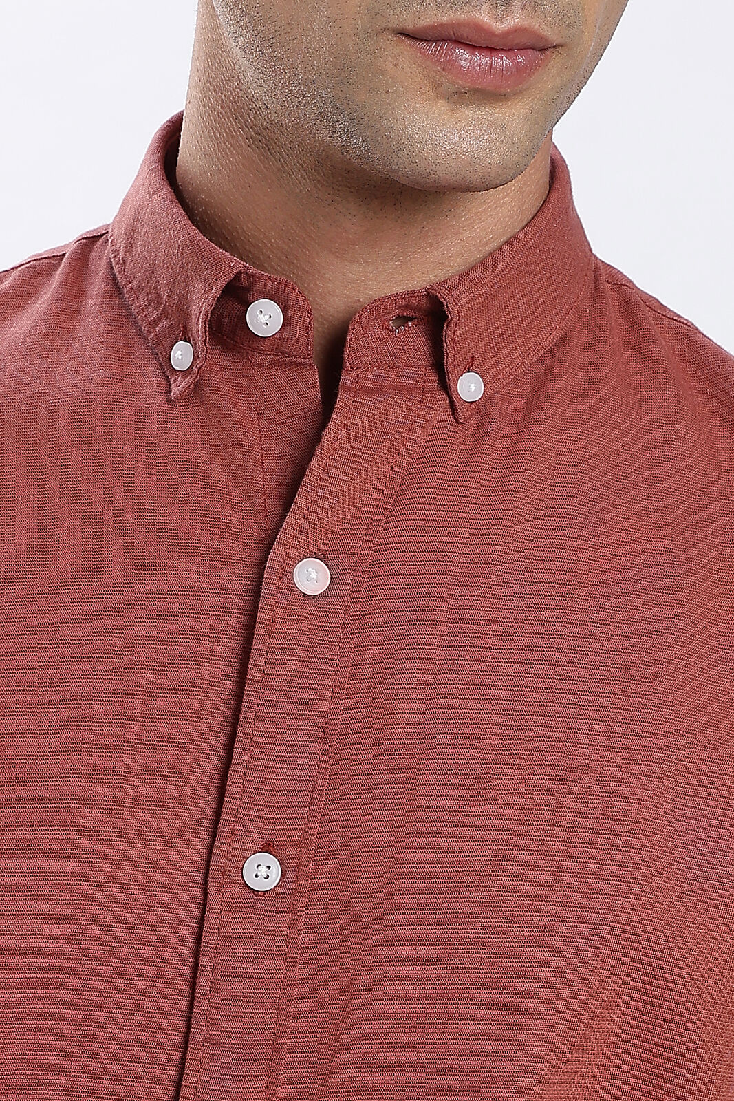Close-up of a rust linen shirt button-down collar